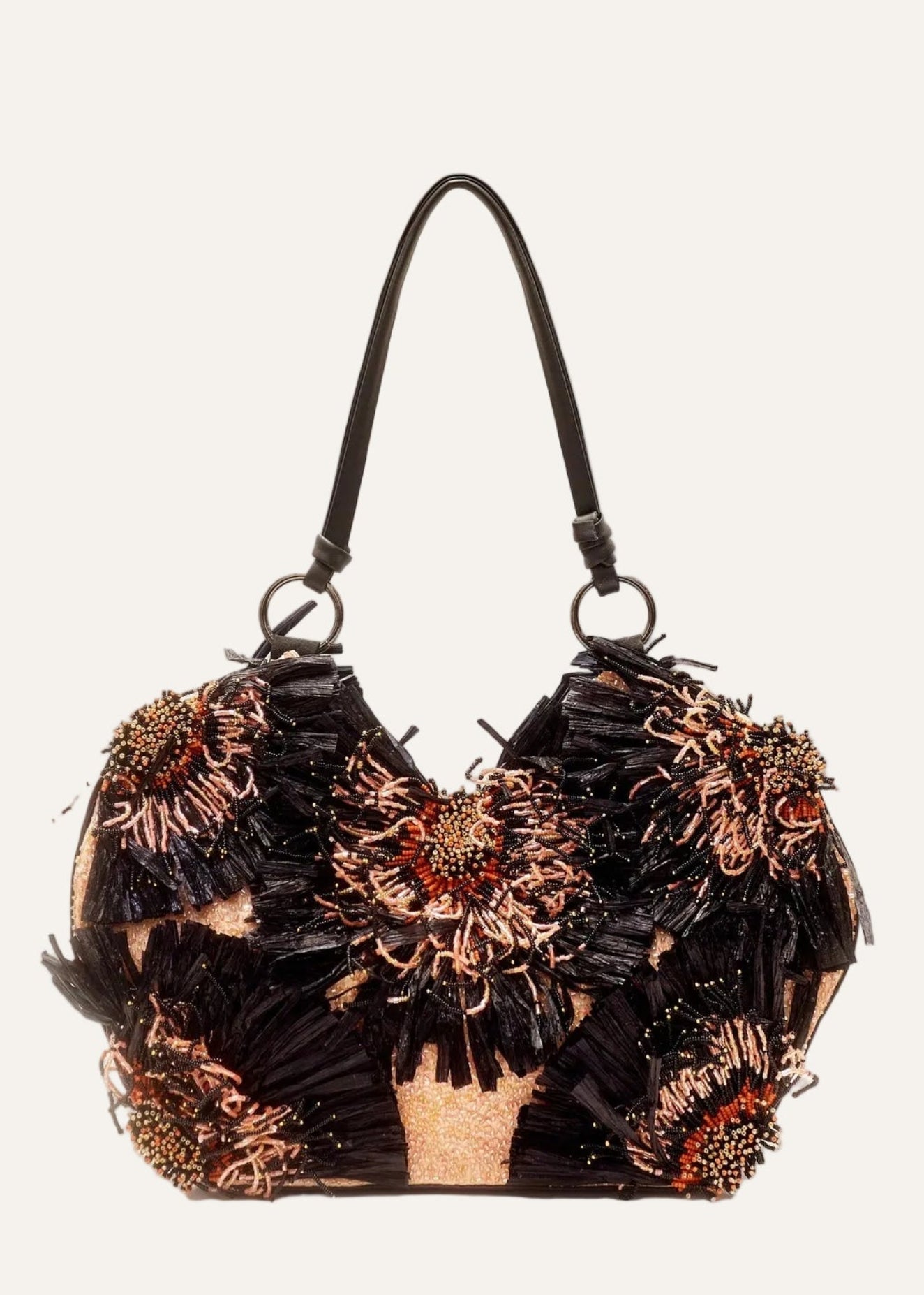 Decorative handbag with feather-like texture and metallic accents on a white background