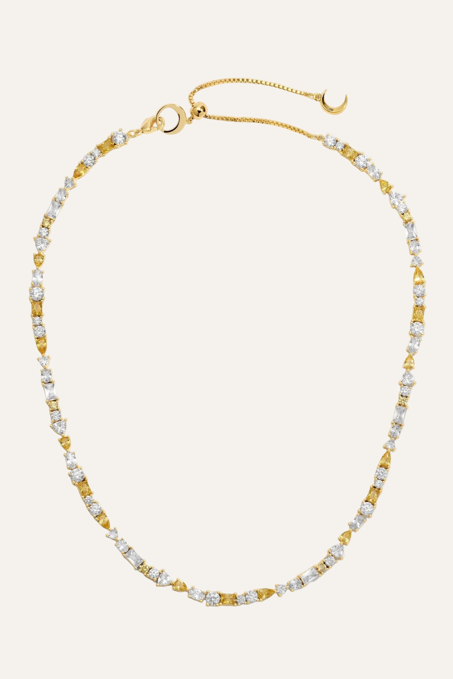 Gold and white beaded necklace on a light gray background