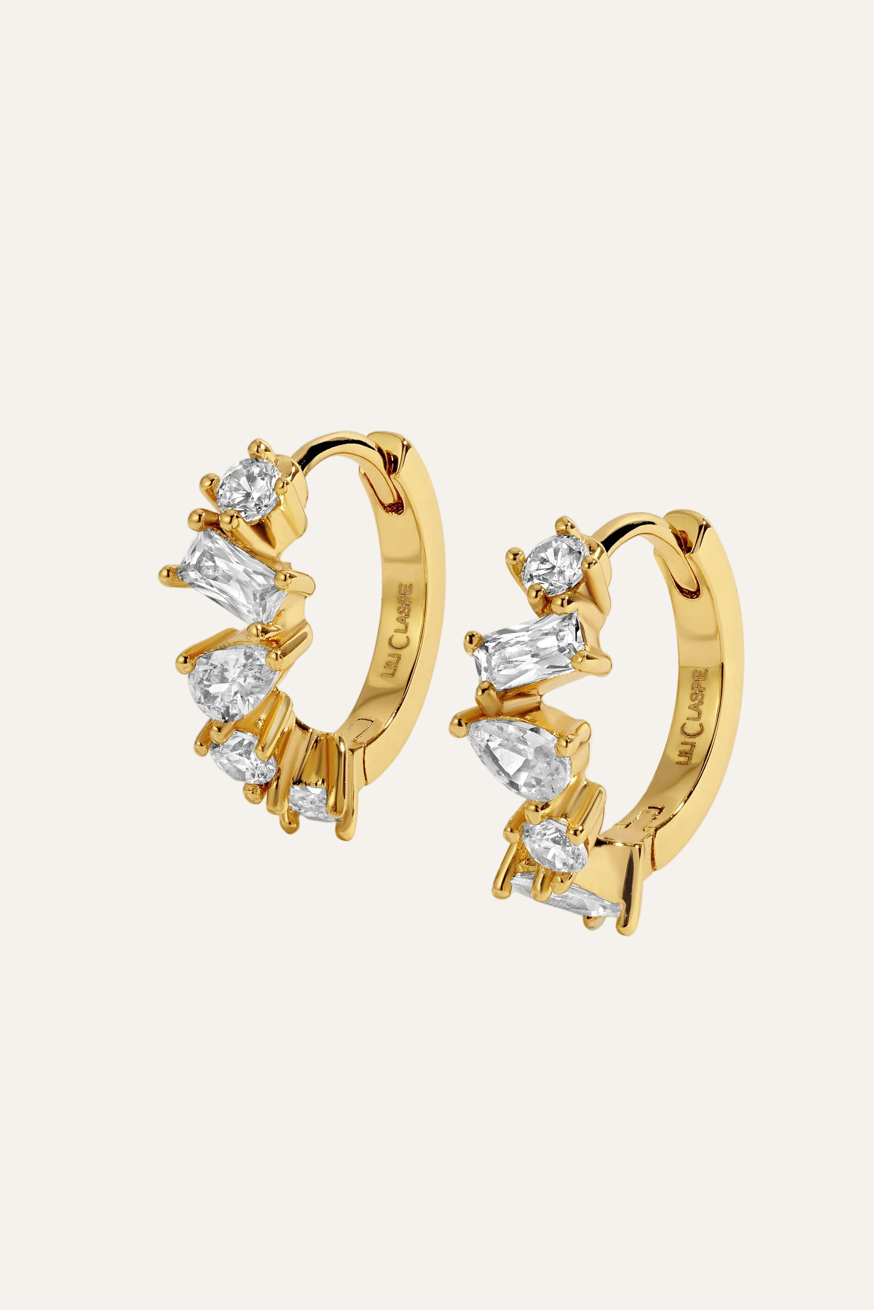 Gold hoop earrings with diamond accents on a light gray background