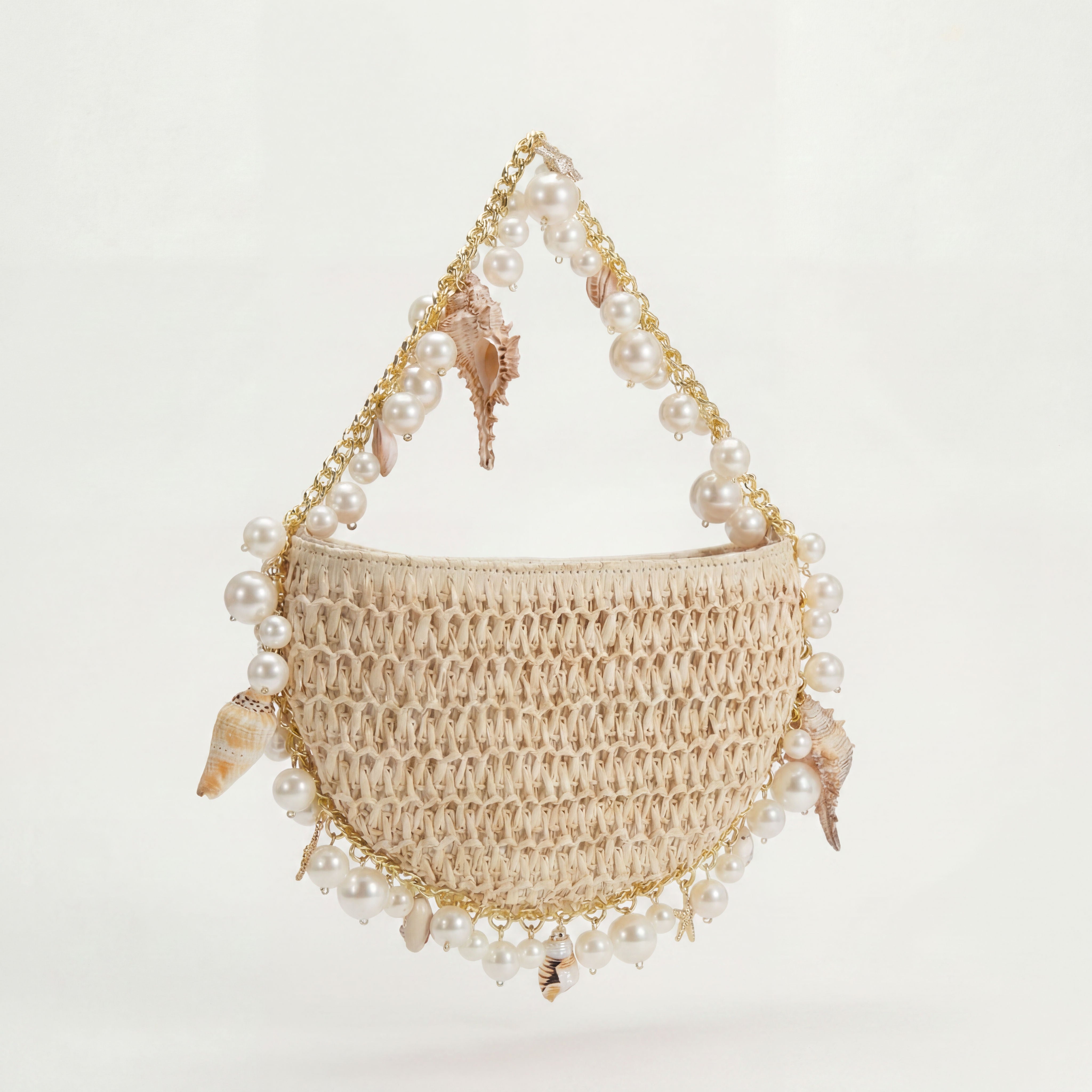 Cream raffia mini shoulder bag with gold hardware, side view, Bahari