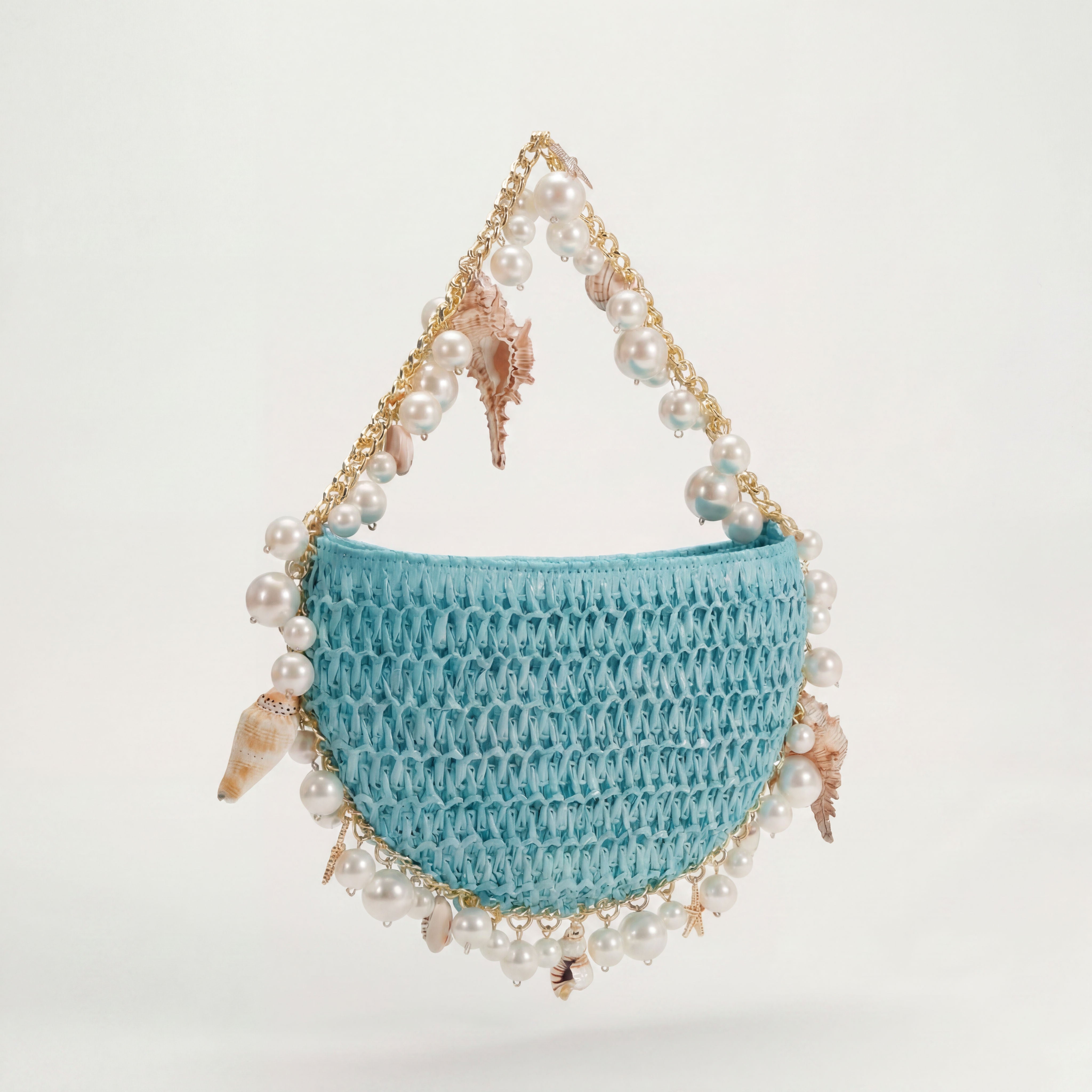 Blue raffia mini shoulder bag with gold hardware, side view, Bahari