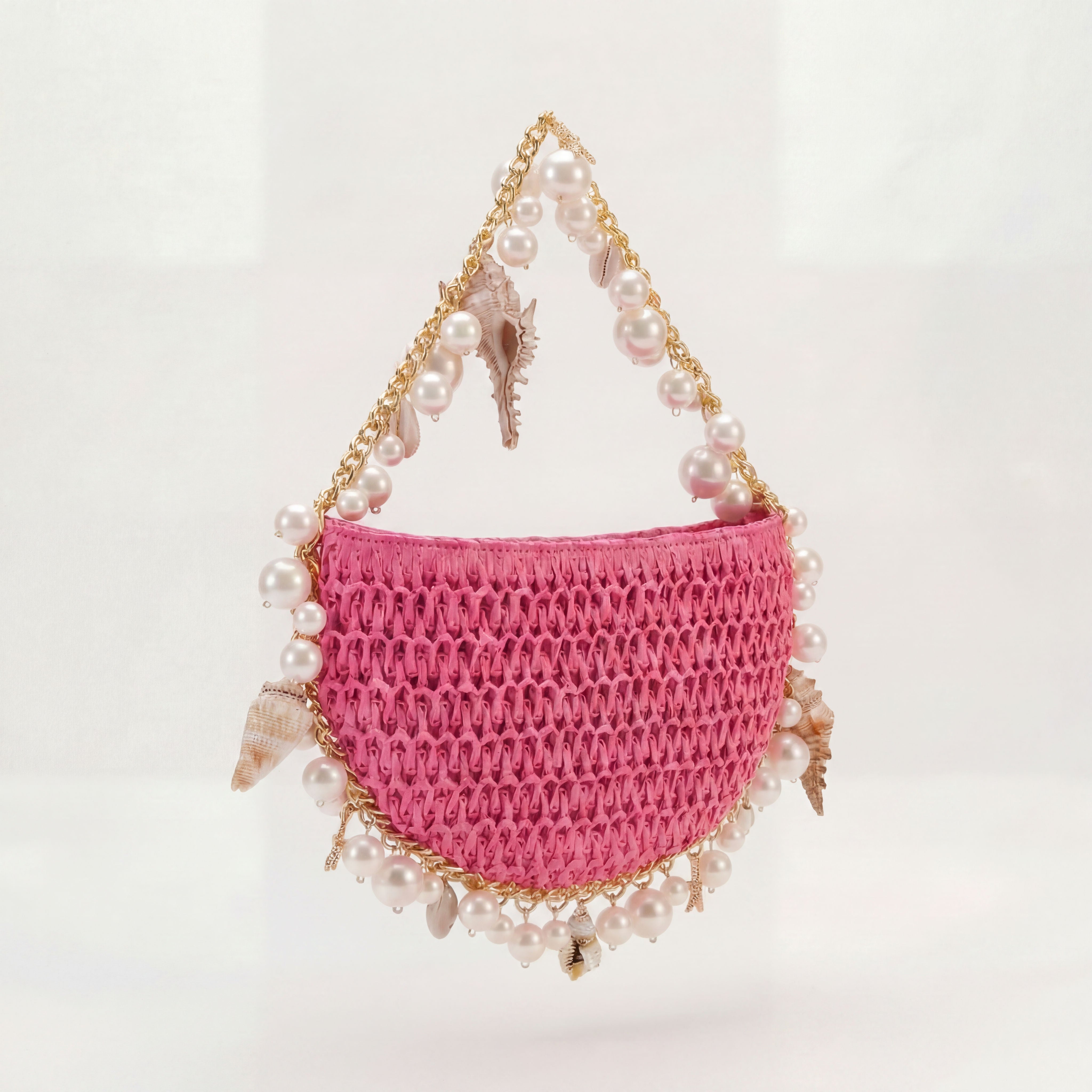 Pink raffia mini shoulder bag with gold hardware, side view, Bahari